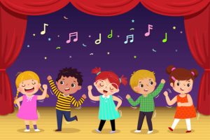 Group of kids dancing and singing a song on the stage. Childrenâs performance.